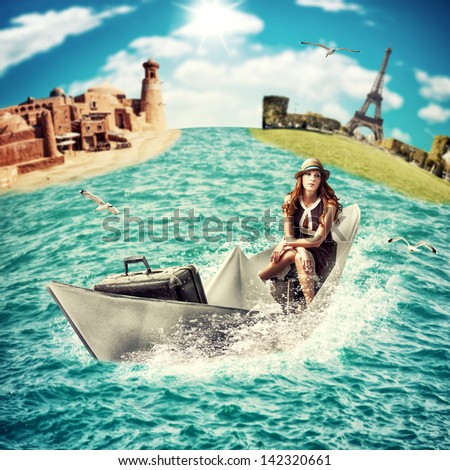 Travel Concept - dreaming about sea cruise around the world.Woman with luggage floats on the paper boat on the ocean