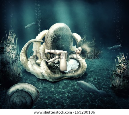 Fantasy underwater marine world. Octopus ensnares young beautiful woman with long hair
