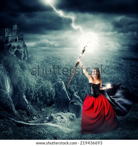 halloween witch making magic and controls the weather. shoots lightning into the sky from the magical staves