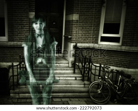 Halloween horror. Scary transparent blurred  woman ghost with ax on porch of house