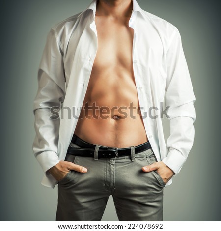 Portrait of muscle man torso in white shirt on grey background