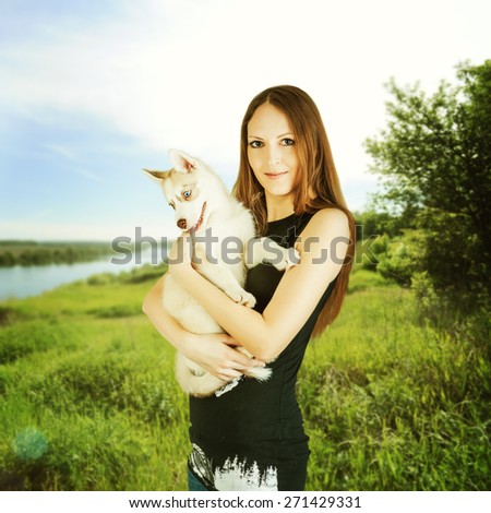 Siberian Husky. young happy woman outdoor holding Siberian Husky dog puppy