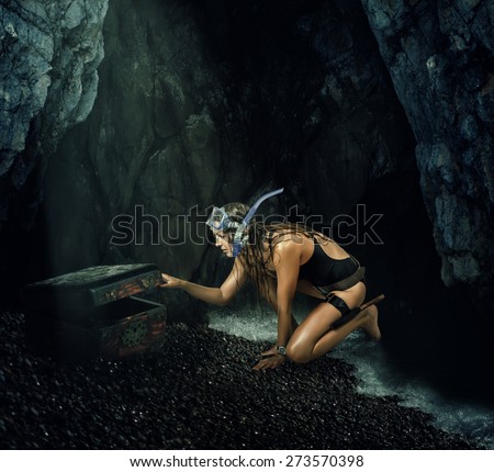 Adventure. Woman treasure hunter opens a treasure chest in the secret cave