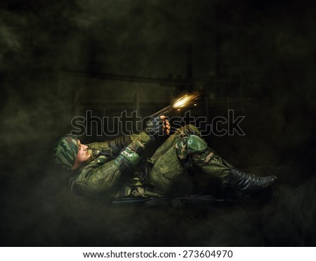 Military man soldier shooting  of handgun. Dark mist background