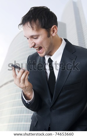 Angry business man shouting on the phone outdoor