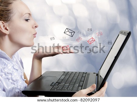 Concept - young attractive woman with laptop computer sending emails on forum, chat or blog. Blogger