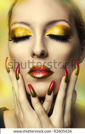 Fashion portrait of cute woman face closeup with bright autumn makeup. Young adult model