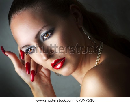 Fashion beauty portrait of young glamour model woman with long red nails add sexy lips with lip-glow closeup