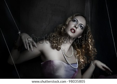 marionette on string. Fashion portrait of blond woman in puppet style
