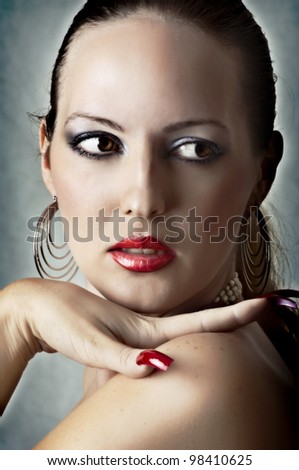 Sexy face of beautiful woman with full red lips and long nails