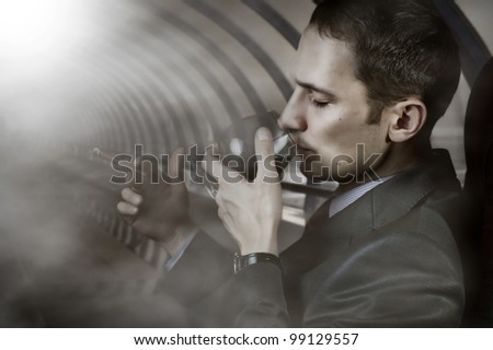 Luxury life. Portrait of business man with glass of brandy and cigar