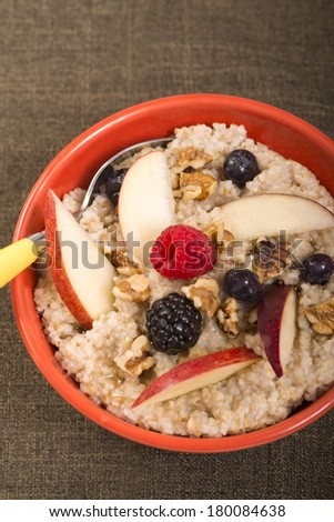 Bowl of delicious steel cut oats with fresh fruit, honey