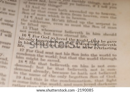 Old bible showing the biblical verse of John 3:16 with surrounding verses blurred