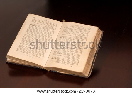 An open old German bible resting on a table awash in warm light