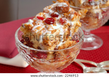 Two crystal goblets of Italian Panettone cranberry bread pudding with an amaretto cream sauce