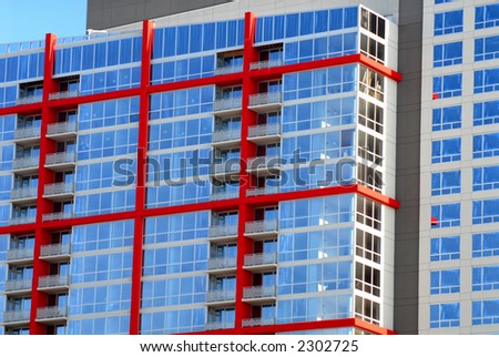 High rise building in Chicago with blue glass and red exterior beams