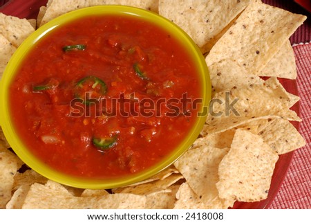 An overhead view of a bowl of salsa with tortilla chips