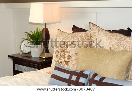 A bedroom scene with bed and nightstand