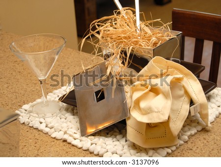 Table place setting in earth tones with napkin, wine glass and straw