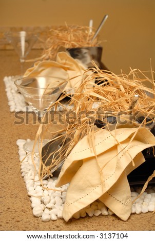 Two place settings in earth tones with wine glasses and straw