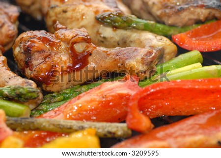BBQ chicken and vegetables cooking on a grill