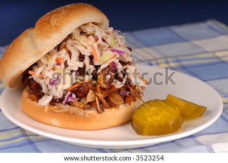 Pulled pork sandwich with cole slaw and pickles