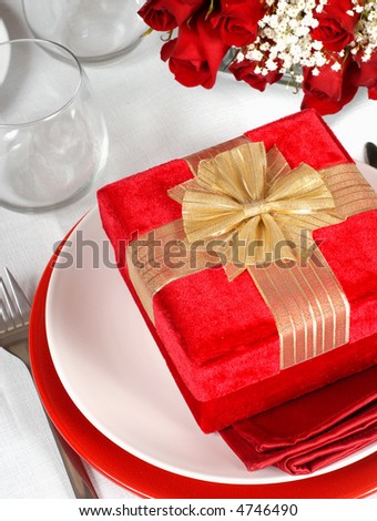 Christmas present in a romantic table setting with roses