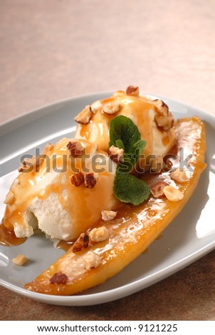 Banana sauteed in brown sugar with vanilla ice cream, caramel sauce and hazelnuts