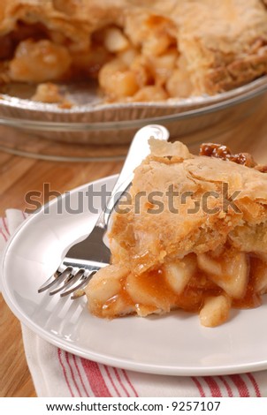 A slice of a deep dish apple pie with a flaky crust