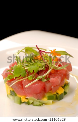 Delicious tartare of tuna and mango with a micro green salad