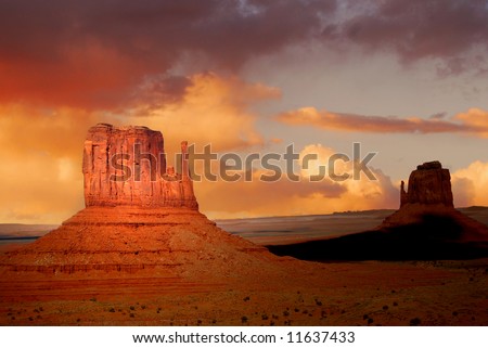 Twin peaks of rock formations in the Navajo Park of Monument Valley Utah known as The Mittens