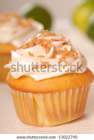 Freshly baked vanilla cupcake with lemon buttercream and toasted coconut