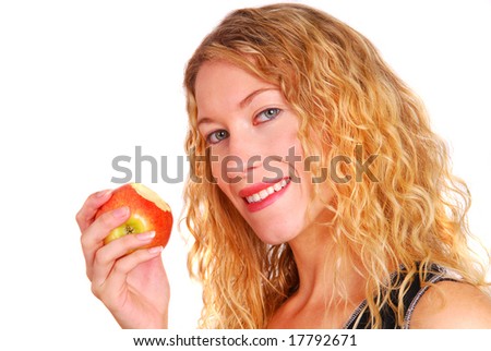 Beautiful healthy young woman eating an apple