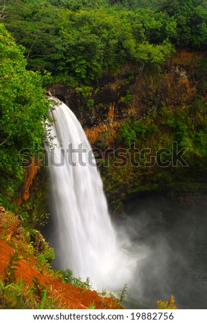 Dramatic view of Wailua Falls in Kauai Hawaii taken with slow shutterspeed