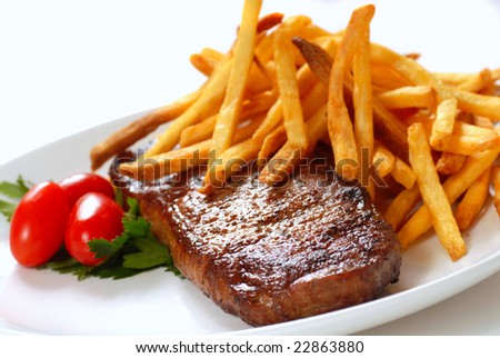 Freshly seared steak with French Fries and tomatoes