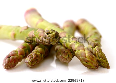 Stalks of fresh organic green asparagus on a reflective surface