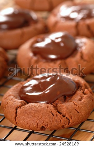 Freshly baked cookies with maraschino cherries covered with chocolate ganache