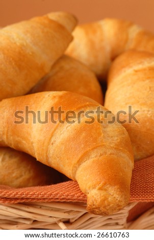Freshly baked crescent rolls in a cloth lined basket