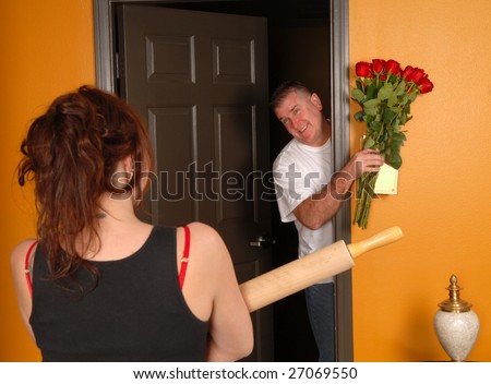 Husband coming home late to angry wife who is holding a rolling pin