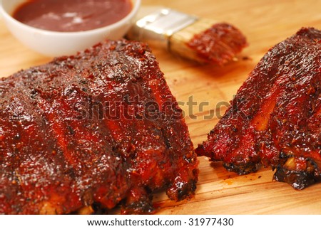 Freshly grilled barbecue spare ribs with tangy dipping barbecue sauce