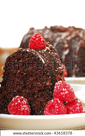 Rich chocolate fudge cake with raspberries, powdered sugar and champagne in a romantic holiday setting.