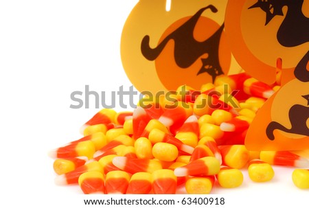 Delicious Halloween candy corn spilling out of a Halloween container.