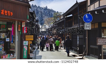 TAKAYAMA, JAPAN - MARCH 26: Unidentified people at Sannomachi Street, the old town area which has museums and old private houses, some survive from Edo period on March 26, 2012 in Takayama, Japan.