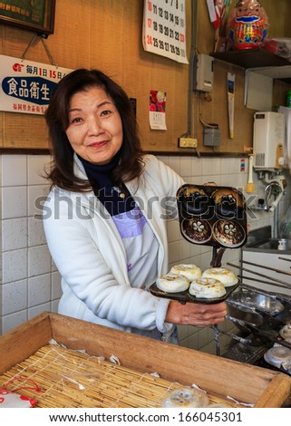 FUKUOKA, JAPAN - NOVEMBER 13: Japanese sweet shop in Fukuoka, Japan on November 13, 2013. Unidentified female shop keeper bakes a plate of japanese sweets in her shop nearby Dazaifu Tenmangu