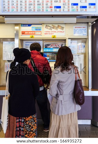 FUKUOKA, JAPAN - NOVEMBER 13: Buying train ticket in Fukuoka, Japan on November 13, 2013. Unidentified people buy train tickets from vending machine at Dazaifu Station