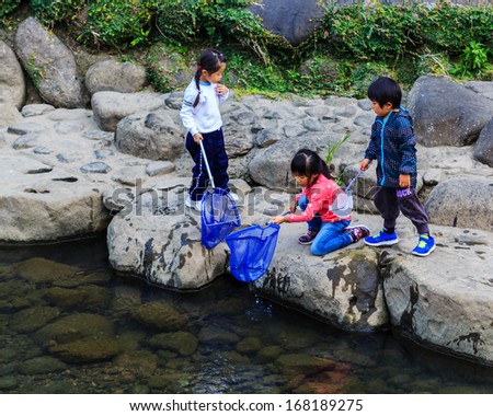 NAGASAKI, JAPAN - NOVEMBER 14: Nakashima River in Nagasaki, Japan on November 14, 2013. Teachers take students out to collect garbage from the river as an activity for environmental learning process