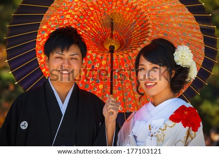 KYOTO, JAPAN - NOVEMBER 19: Japanese Couple in Kyoto, Japan on November 19, 2013. Unidentified groom and bride dress traditional costumes for their wedding ceremony