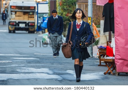 KYOTO, JAPAN - NOVEMBER 20: Japanese Student in Kyoto, Japan on November 20, 2013. Unidentified female Japanese student travels to school in the morning
