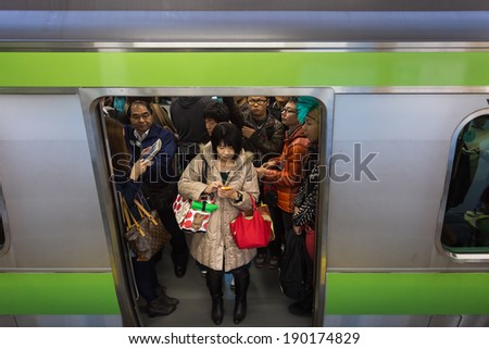 Tokyo, Japan - November 23 2013: Tokyo train is always packed with people all through the day and especially in rush hours.