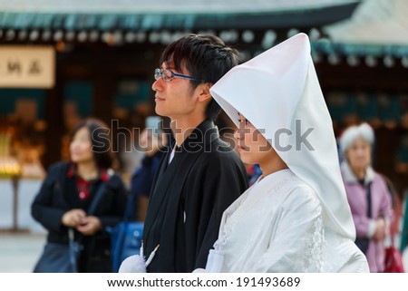 TOKYO, JAPAN - NOVEMBER 23: Wedding Ceremony in Tokyo, Japan on November 23, 2013. Unidentified groom and bride attend a traditional wedding ceremony at Meiji shrine